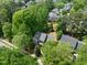 A stunning aerial view of a two-story home shaded by mature trees in a quiet neighborhood setting at 504 Cameron Glen Dr, Apex, NC 27502
