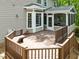 Wooden back deck featuring built-in bench seating and railing, offering outdoor space for relaxation and entertaining at 504 Cameron Glen Dr, Apex, NC 27502