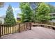 Large wooden deck overlooking the backyard, featuring built-in seating and a beautiful view at 504 Cameron Glen Dr, Apex, NC 27502