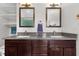 Updated bathroom features double sink vanity with granite countertop, wood cabinets and decorative mirrors at 504 Cameron Glen Dr, Apex, NC 27502