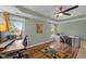 Inviting bedroom offering tray ceiling, wood floor, ceiling fan, and windows overlooking the greenery at 504 Cameron Glen Dr, Apex, NC 27502