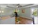 Inviting bedroom offering tray ceiling, wood floor, ceiling fan, and windows overlooking the greenery at 504 Cameron Glen Dr, Apex, NC 27502