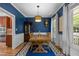 Stylish dining room with blue walls, hardwood floors, and wainscoting at 504 Cameron Glen Dr, Apex, NC 27502