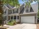 Attractive two-story home featuring a two-car garage, covered porch, and mature trees at 504 Cameron Glen Dr, Apex, NC 27502