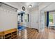 Inviting foyer featuring hardwood floors, coat storage, and views into the dining and play rooms at 504 Cameron Glen Dr, Apex, NC 27502