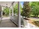 Covered front porch showing white railings and columns with views of the front yard and street at 504 Cameron Glen Dr, Apex, NC 27502