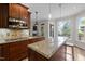 Kitchen featuring wood cabinets, granite countertops, stainless steel microwave, and view of the fireplace at 504 Cameron Glen Dr, Apex, NC 27502