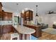 Bright kitchen with a central island and granite countertop open to the living room. Stainless steel appliances included at 504 Cameron Glen Dr, Apex, NC 27502