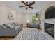 Cozy living room features a ceiling fan, blue rug, a fireplace, and two sofas at 504 Cameron Glen Dr, Apex, NC 27502