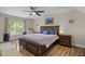 Spacious main bedroom features a ceiling fan, hardwood floors, a large window, and tasteful decor at 504 Cameron Glen Dr, Apex, NC 27502