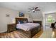Spacious main bedroom features a ceiling fan, hardwood floors, a large window, and tasteful decor at 504 Cameron Glen Dr, Apex, NC 27502