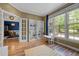 Bright play room with hardwood floors, large windows, and views into the dining room at 504 Cameron Glen Dr, Apex, NC 27502