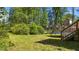 Lush backyard with mature trees, and partial view of trampoline at 508 2Nd Street St, Apex, NC 27502