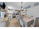 Bright dining room featuring a chandelier, stylish chairs, and an adjacent, modern kitchen area at 508 2Nd Street St, Apex, NC 27502
