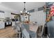Bright dining room featuring a chandelier, stylish chairs, and an adjacent, modern kitchen area at 508 2Nd Street St, Apex, NC 27502