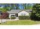 Inviting single-story home with a gray exterior, well-manicured lawn, shrubbery and a charming front porch at 508 2Nd Street St, Apex, NC 27502