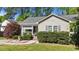 Quaint one-story home featuring well-kept landscaping, a charming porch, and neutral-colored siding at 508 2Nd Street St, Apex, NC 27502