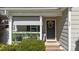 Close up of front porch with outdoor seating and decorative wreath on the front door at 508 2Nd Street St, Apex, NC 27502