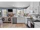 Kitchen with white cabinetry, stainless steel appliances, stylish backsplash, and modern lighting at 508 2Nd Street St, Apex, NC 27502