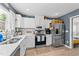Bright kitchen with white cabinets, stainless steel appliances, and white tile backsplash at 508 2Nd Street St, Apex, NC 27502