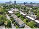 An aerial view showcases the neighborhood with tree-lined streets and the cityscape in the distance at 511 N Person St # 101, Raleigh, NC 27604