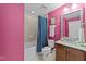 Bright bathroom with pink walls, granite vanity, and a shower over the bathtub at 511 N Person St # 101, Raleigh, NC 27604