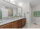 Double sink bathroom with granite counters and large mirror at 511 N Person St # 101, Raleigh, NC 27604