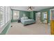 This bedroom has a ceiling fan, large window and neutral carpet at 511 N Person St # 101, Raleigh, NC 27604