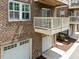 Brick building featuring a private balcony and a single car garage at 511 N Person St # 101, Raleigh, NC 27604