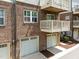 Brick townhouse featuring a private balcony and a single car garage at 511 N Person St # 101, Raleigh, NC 27604