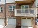 Brick townhouse featuring a private balcony and a single car garage at 511 N Person St # 101, Raleigh, NC 27604