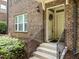 Brick exterior with front door and small wrought iron railing leading to the entrance of the home at 511 N Person St # 101, Raleigh, NC 27604