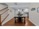 Open concept kitchen featuring an island and a dining table with white cabinets and stainless steel appliances at 511 N Person St # 101, Raleigh, NC 27604