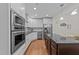Well-equipped kitchen with stainless steel appliances, white cabinets, and a dark island countertop at 511 N Person St # 101, Raleigh, NC 27604