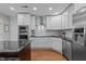 Modern kitchen features white cabinetry, granite countertops, stainless appliances, and hardwood floors at 511 N Person St # 101, Raleigh, NC 27604