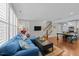 Open concept living room featuring wood floors, ample natural light, and access to the dining area at 511 N Person St # 101, Raleigh, NC 27604
