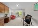 Well-lit office with built-in wooden cabinets, a desk, a comfortable chair, and an outdoor patio at 511 N Person St # 101, Raleigh, NC 27604