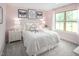 A bright bedroom with pink walls, natural light, and a comfortable bed creates a warm and inviting space at 533 Freedom Trail Dr, Willow Springs, NC 27592
