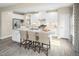 Modern kitchen island with granite counters, seating, and ample cabinet space, perfect for cooking at 533 Freedom Trail Dr, Willow Springs, NC 27592