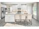 Stunning kitchen island with seating, complemented by white cabinetry and granite countertops at 533 Freedom Trail Dr, Willow Springs, NC 27592