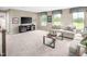 Spacious living room with comfortable seating, entertainment center, and large windows at 533 Freedom Trail Dr, Willow Springs, NC 27592