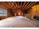 Unfinished attic featuring wood framing, plywood subfloor, and natural light from a small window at 5605 Cary Glen Blvd, Cary, NC 27519