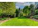 Manicured lawn and garden in the backyard offers peaceful and private outdoor space at 5605 Cary Glen Blvd, Cary, NC 27519