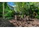 Secluded backyard seating area with wicker chairs, ideal for relaxing in nature at 5605 Cary Glen Blvd, Cary, NC 27519