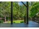 View of the backyard from the deck with a manicured lawn and mature trees at 5605 Cary Glen Blvd, Cary, NC 27519