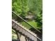 Wood stairs lead to a lush backyard with manicured lawn and mature trees offering shade at 5605 Cary Glen Blvd, Cary, NC 27519