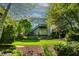 View of the home's backyard featuring a multi-tiered deck and lush greenery at 5605 Cary Glen Blvd, Cary, NC 27519