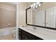 Bathroom with a black framed mirror, tiled shower, and granite counters at 5605 Cary Glen Blvd, Cary, NC 27519