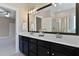 Bathroom featuring double sinks, a large mirror, and modern fixtures at 5605 Cary Glen Blvd, Cary, NC 27519