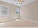 Neutral bedroom features a ceiling fan and natural light from two large windows at 5605 Cary Glen Blvd, Cary, NC 27519